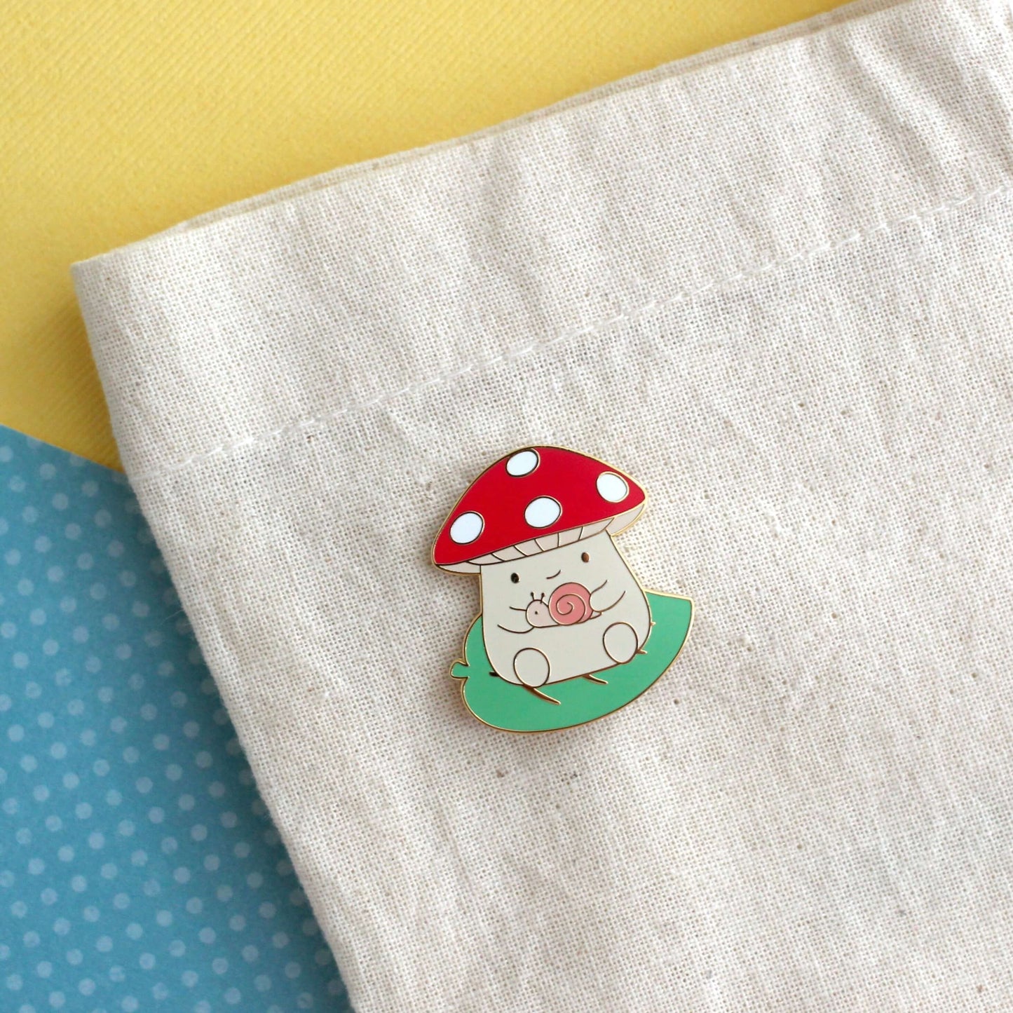 Mushroom on Leaf and holding a Snail Enamel Pin