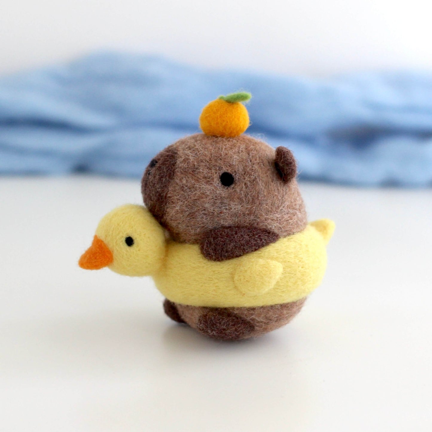 Needle Felted Capybara in Duck Floatie with Yuzu on its Head