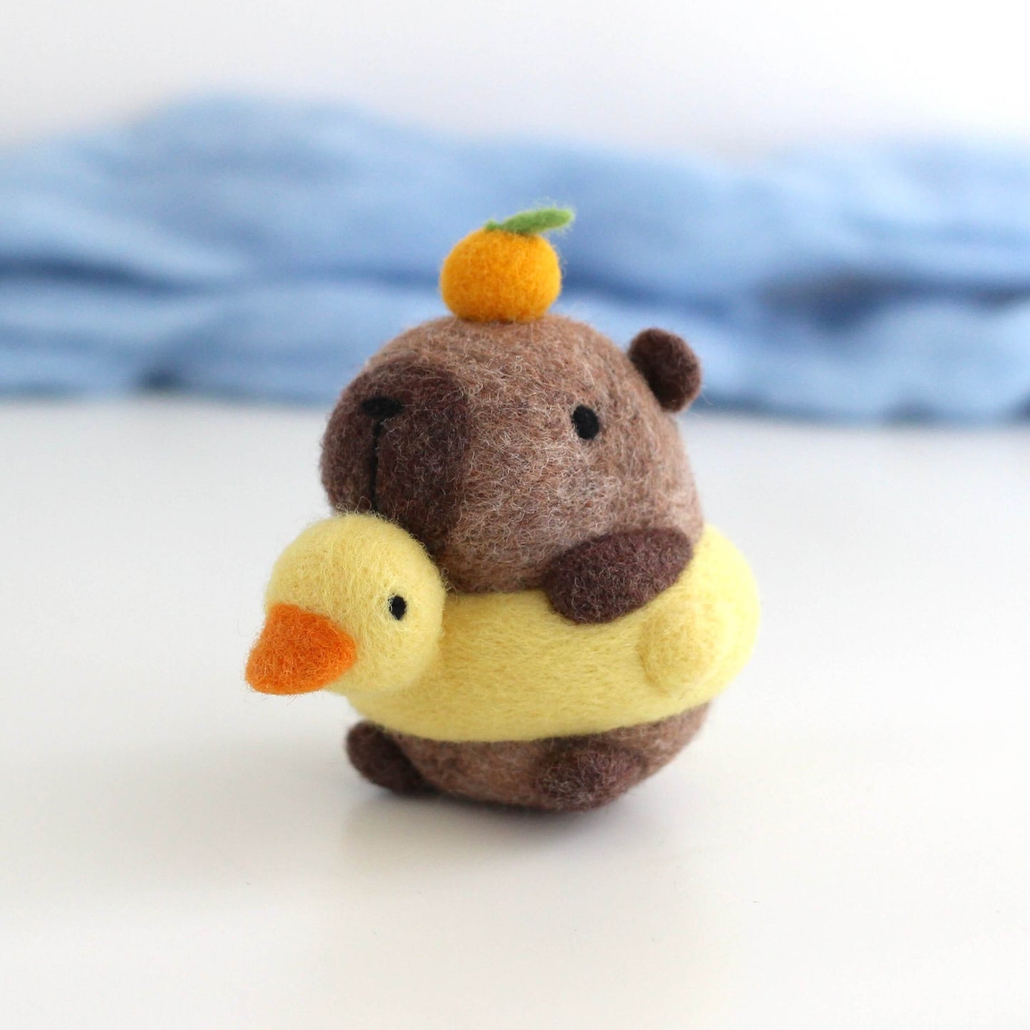 Needle Felted Capybara in Duck Floatie with Yuzu on its Head