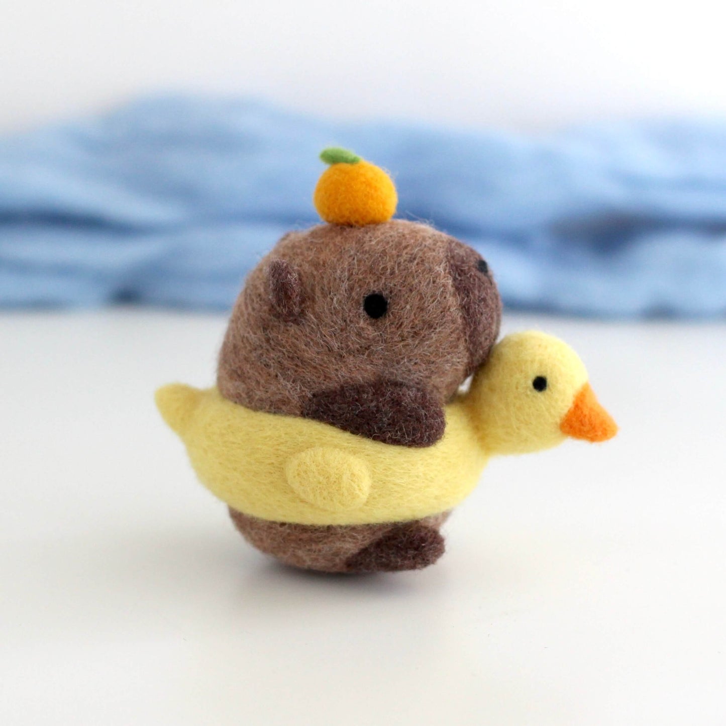Needle Felted Capybara in Duck Floatie with Yuzu on its Head