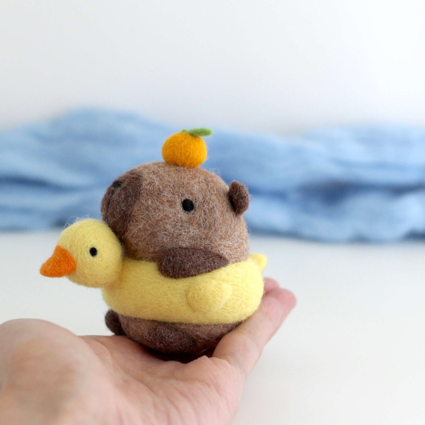 Needle Felted Capybara in Duck Floatie with Yuzu on its Head