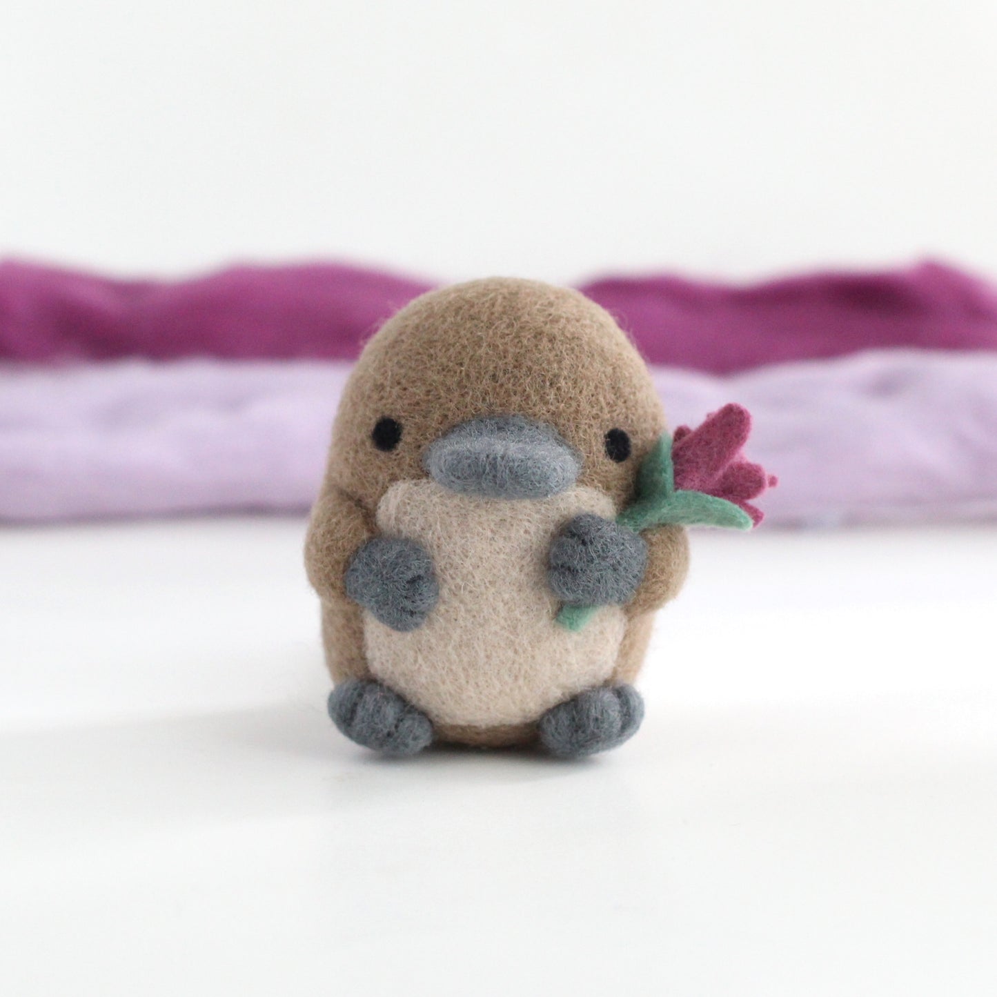 Needle Felted Platypus holding a Wildflower (Magenta)