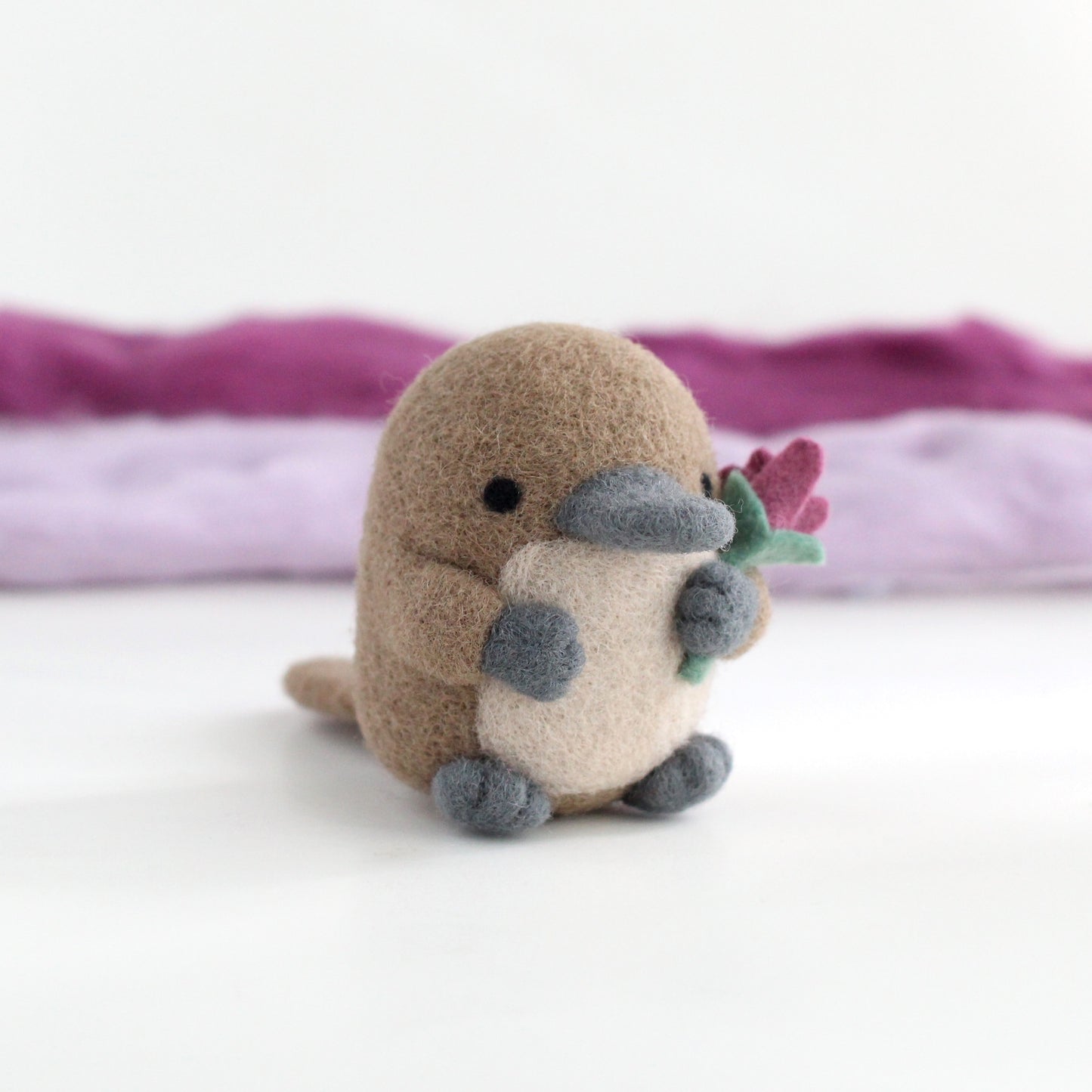 Needle Felted Platypus holding a Wildflower (Magenta)
