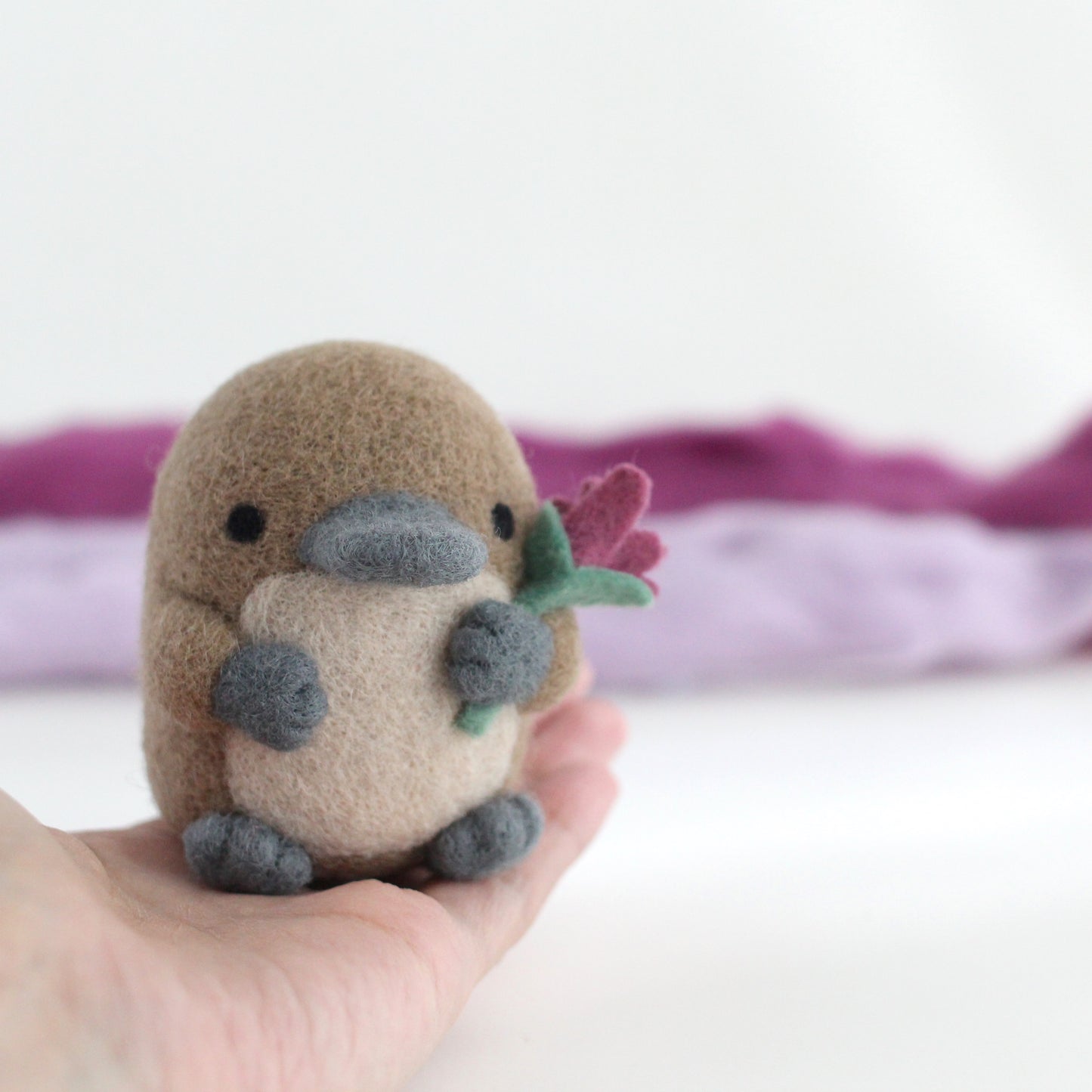 Needle Felted Platypus holding a Wildflower (Magenta)