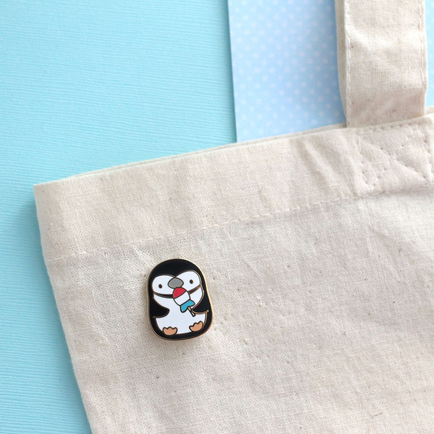 Chinstrap Penguin Holding Rocket Fish Ice Pop Enamel Pin