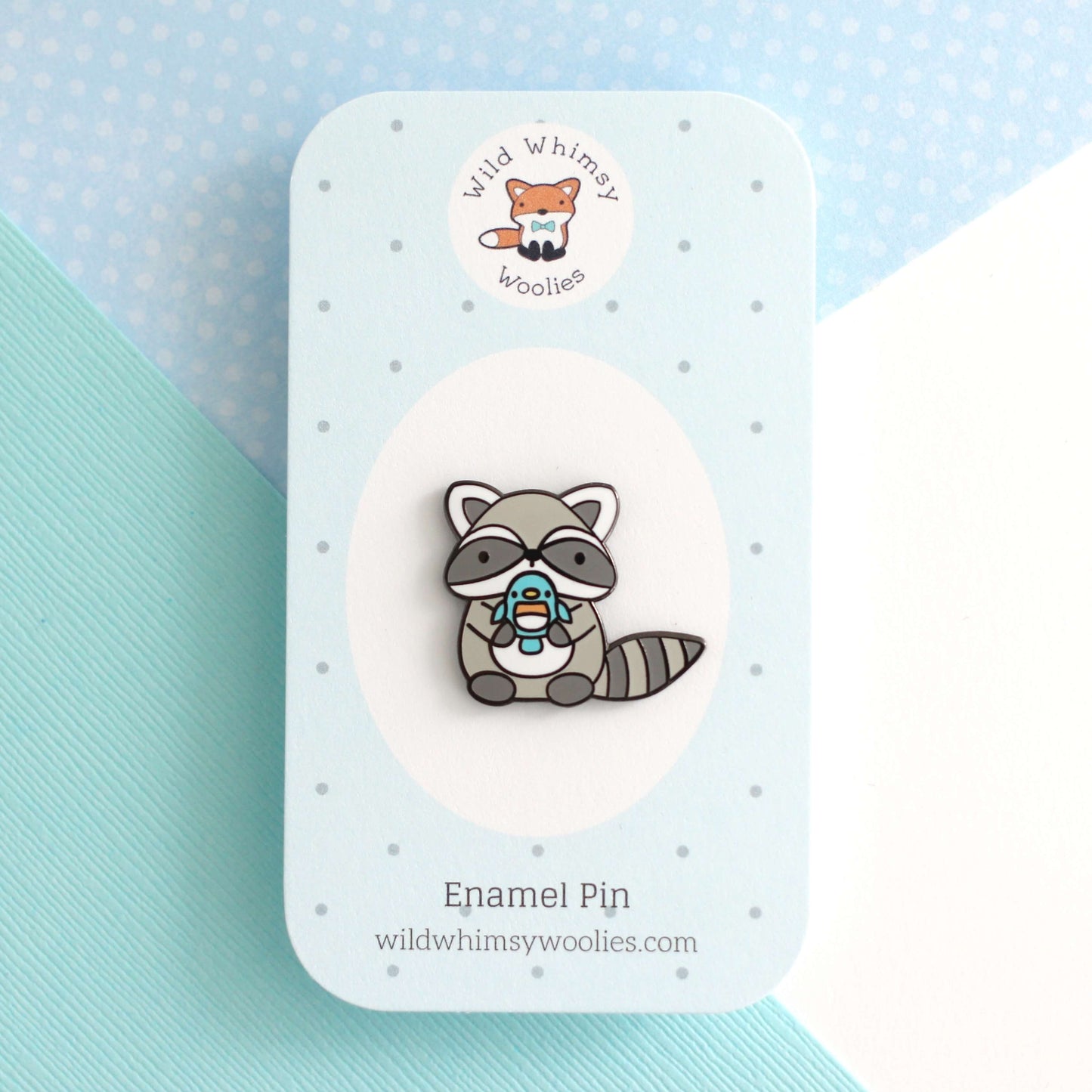 Raccoon holding Blue Bird Enamel Pin