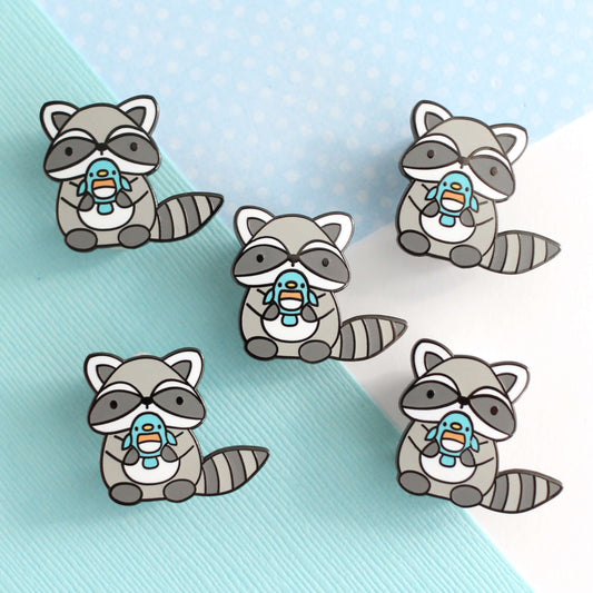 Raccoon holding Blue Bird Enamel Pin