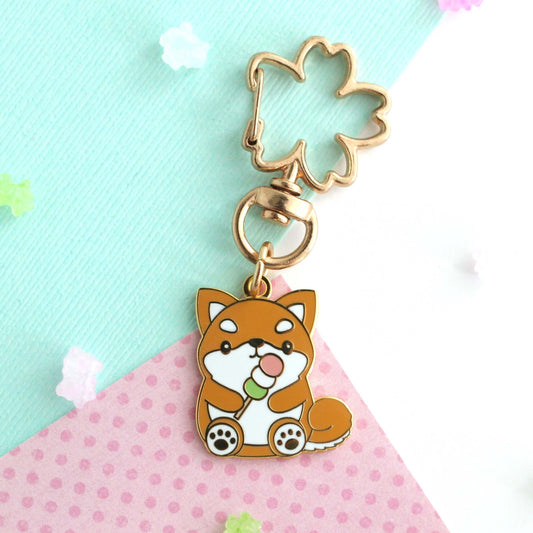 Shiba Inu holding a Dango Enamel Keychain: Sakura Swivel Key Ring