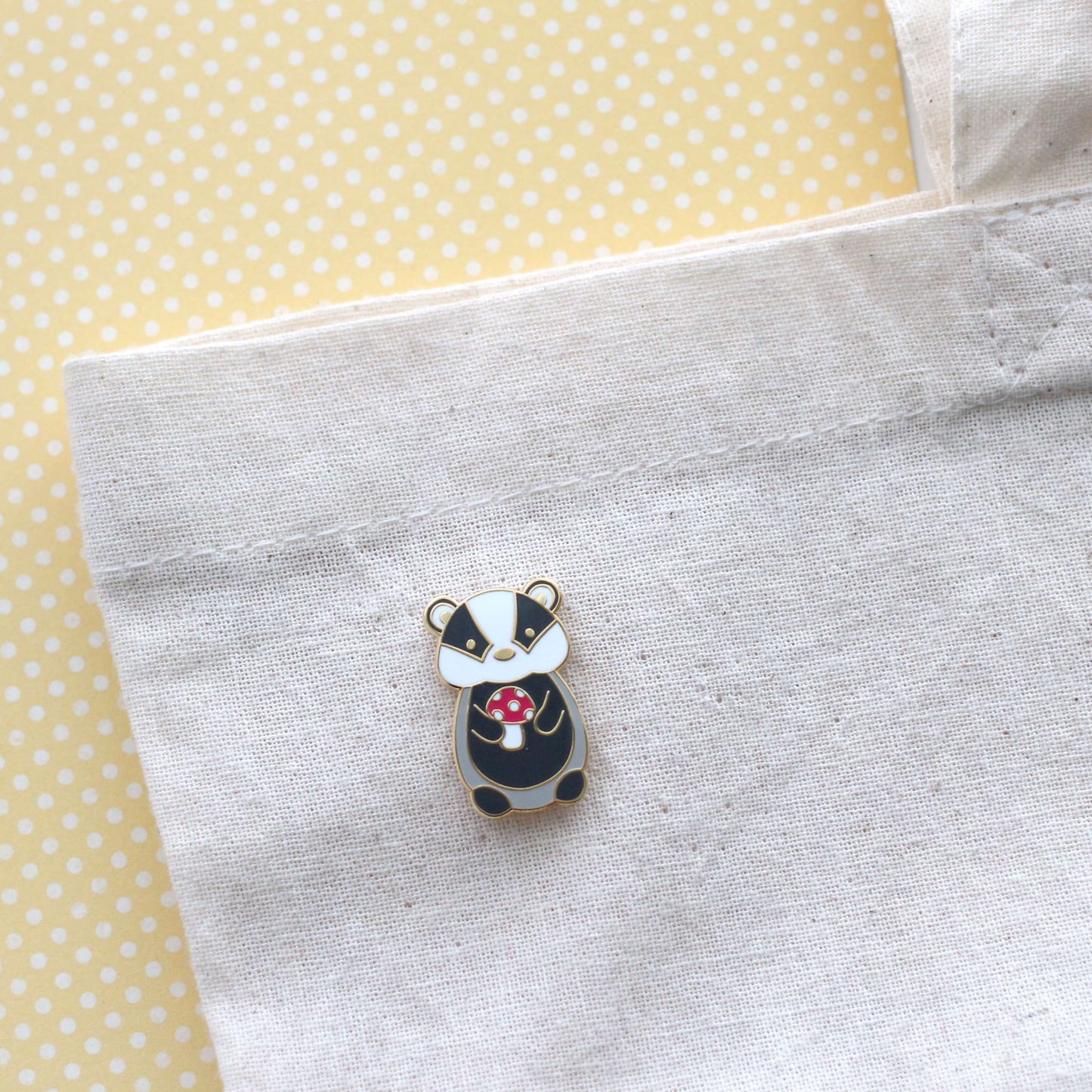 Badger holding Red Mushroom Enamel Pin. Woodland Animal Badge