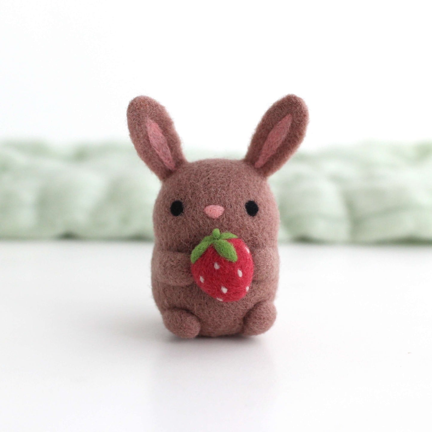 Needle Felted Bunny holding a Strawberry