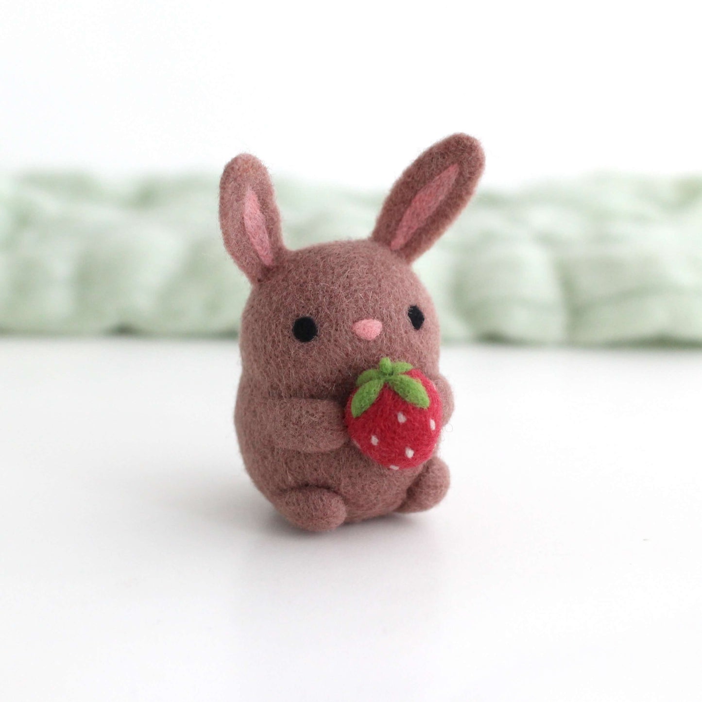 Needle Felted Bunny holding a Strawberry