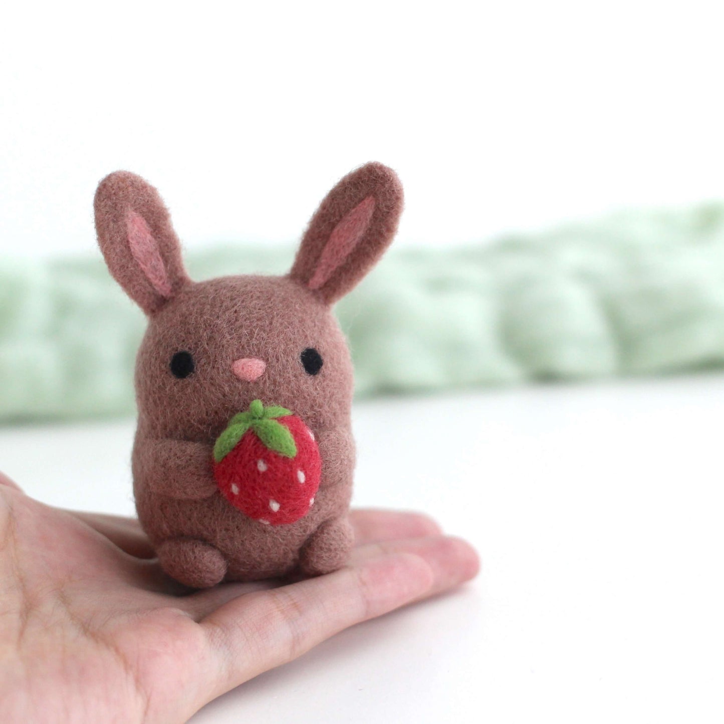 Needle Felted Bunny holding a Strawberry