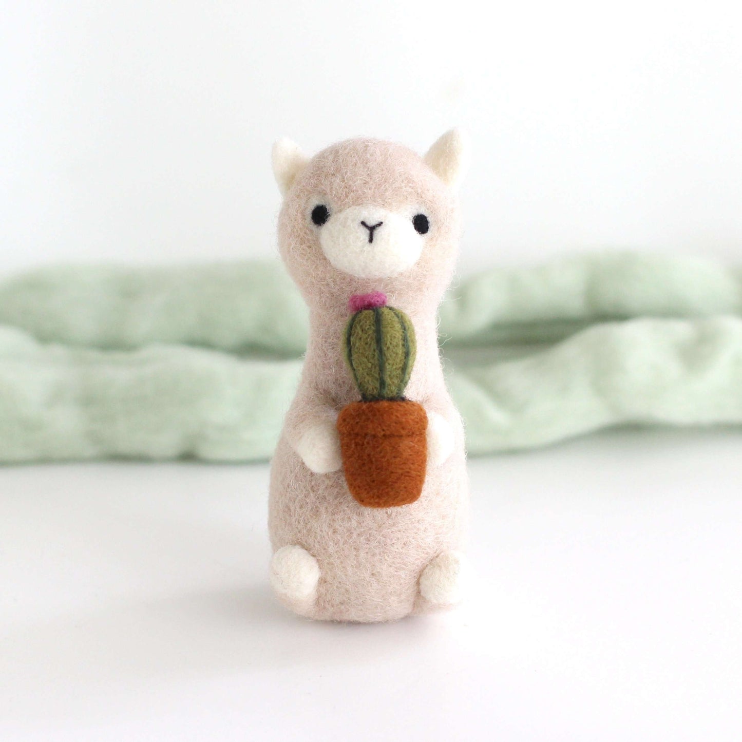 Needle Felted Alpaca holding Cactus