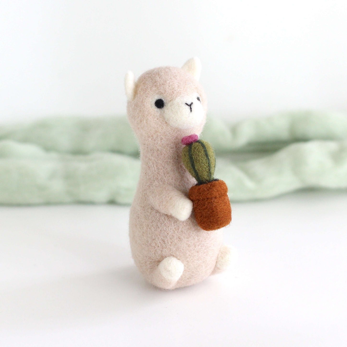 Needle Felted Alpaca holding Cactus