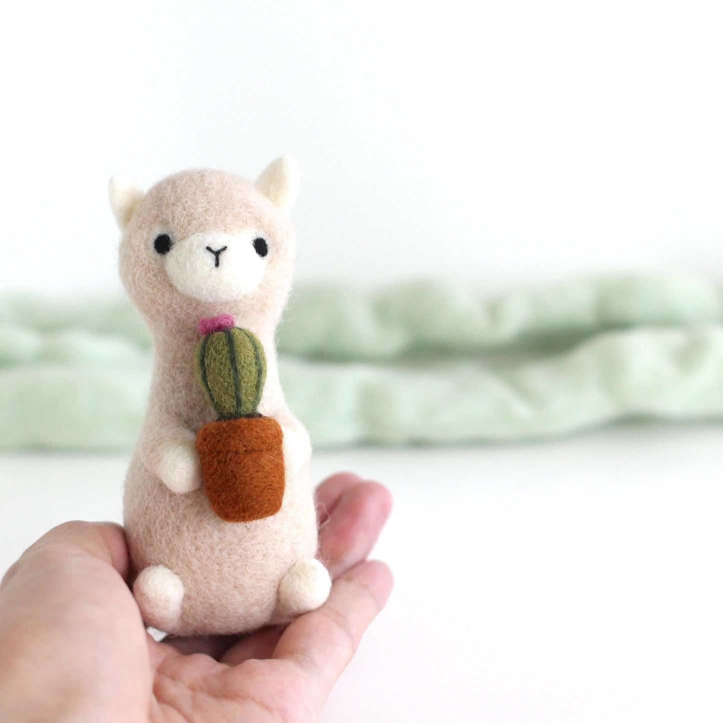 Needle Felted Alpaca holding Cactus