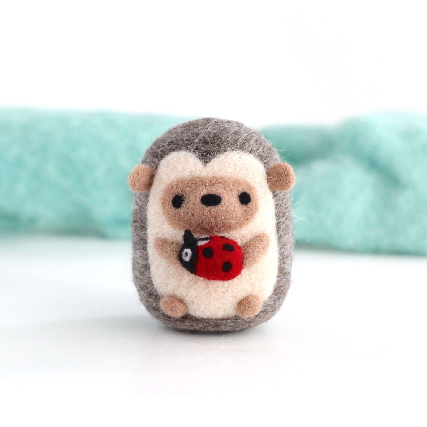 Needle Felted Hedgehog holding Ladybug by Wild Whimsy Woolies
