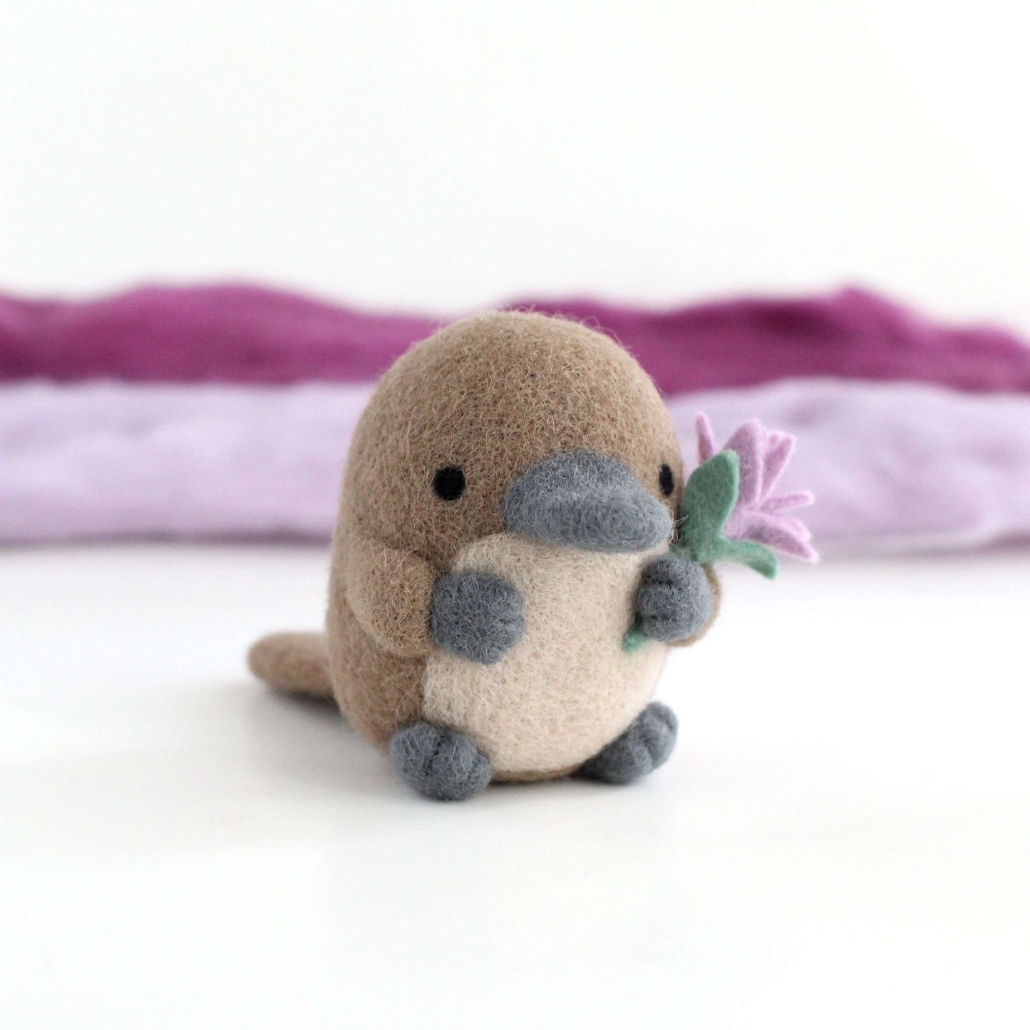Needle Felted Platypus holding a Wildflower (Light purple)