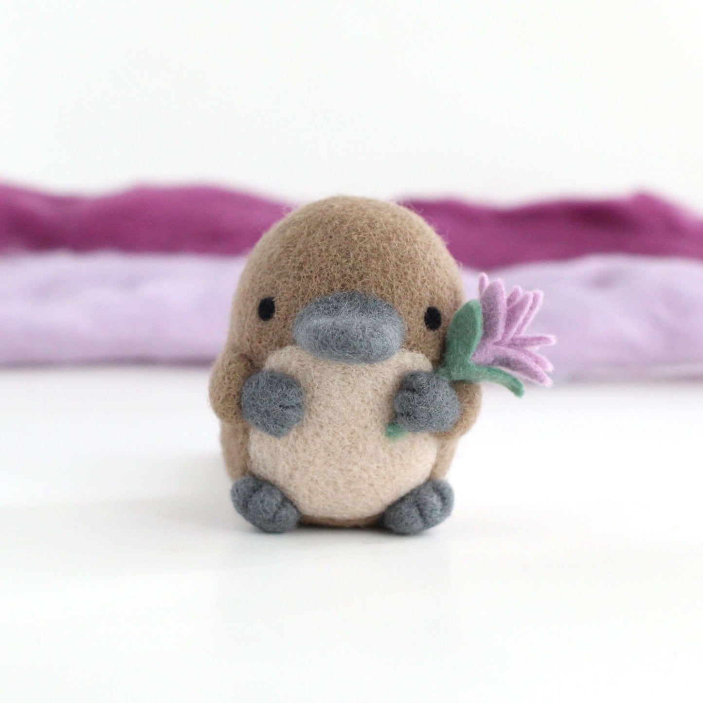 Needle Felted Platypus holding a Wildflower (Light purple)