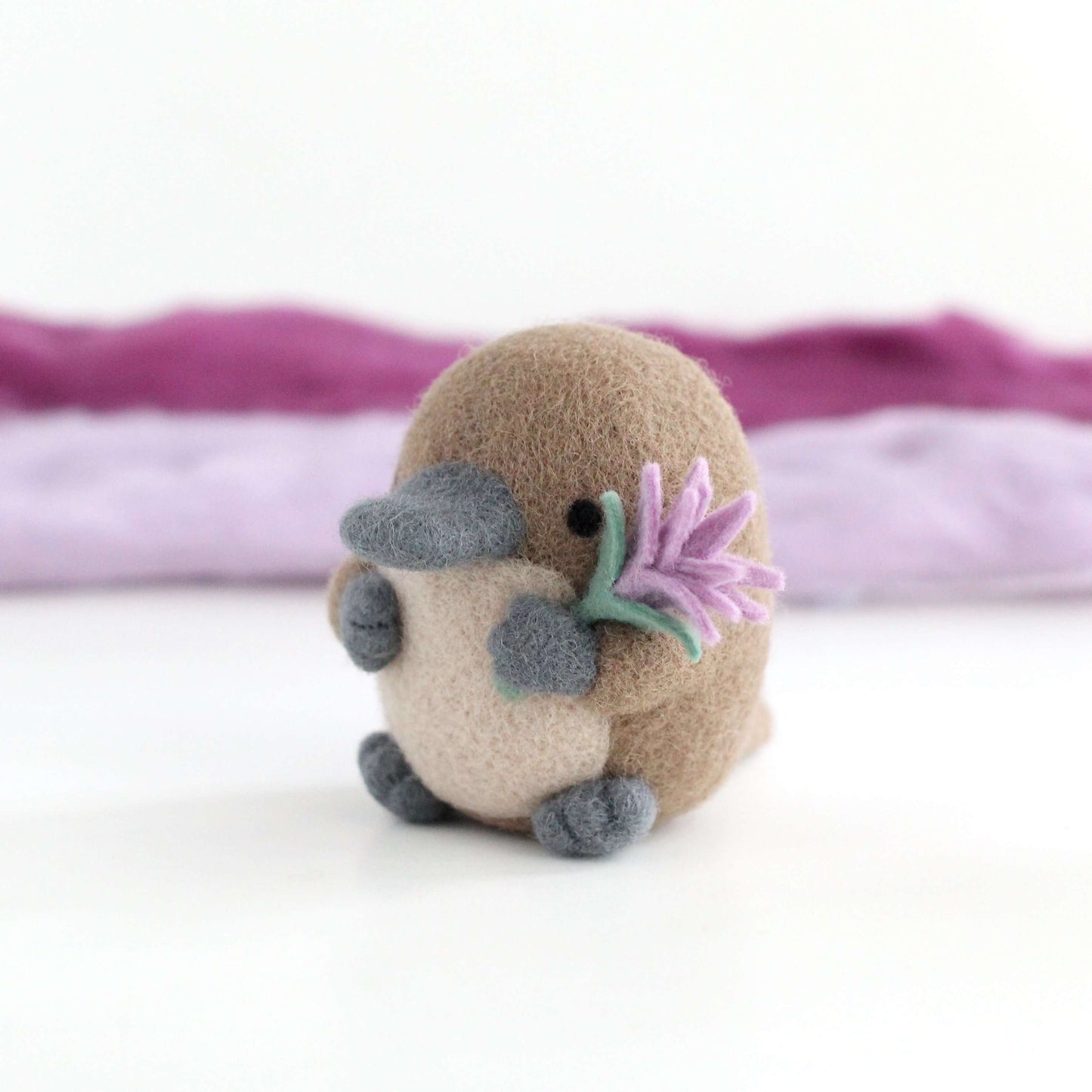 Needle Felted Platypus holding a Wildflower (Light purple)