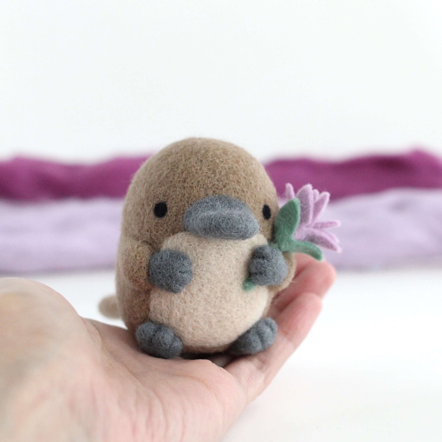 Needle Felted Platypus holding a Wildflower (Light purple)