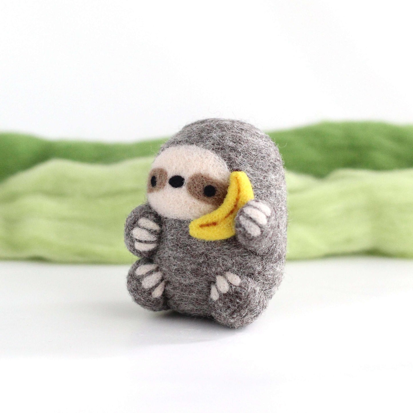 Needle Felted Sloth holding Banana Phone
