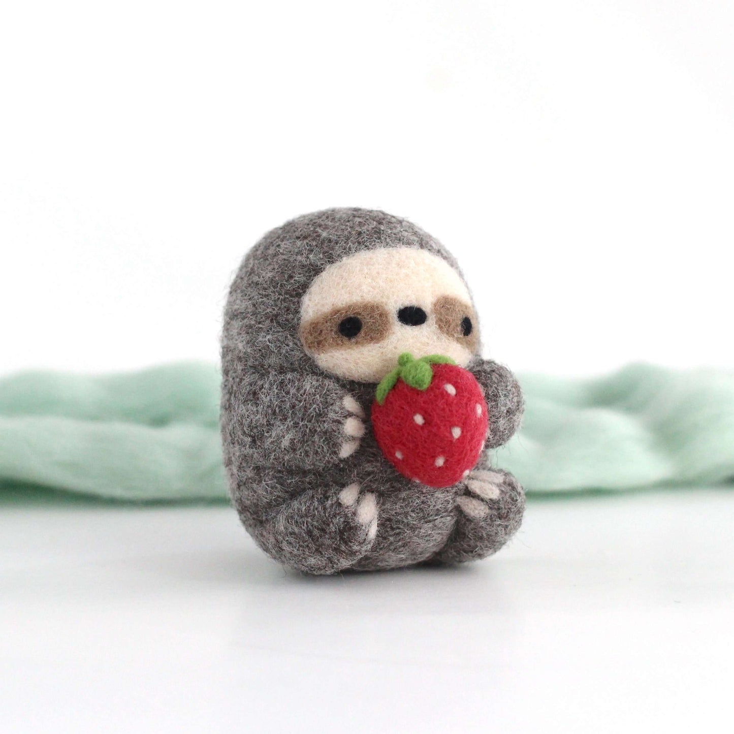 Needle Felted Sloth holding Strawberry