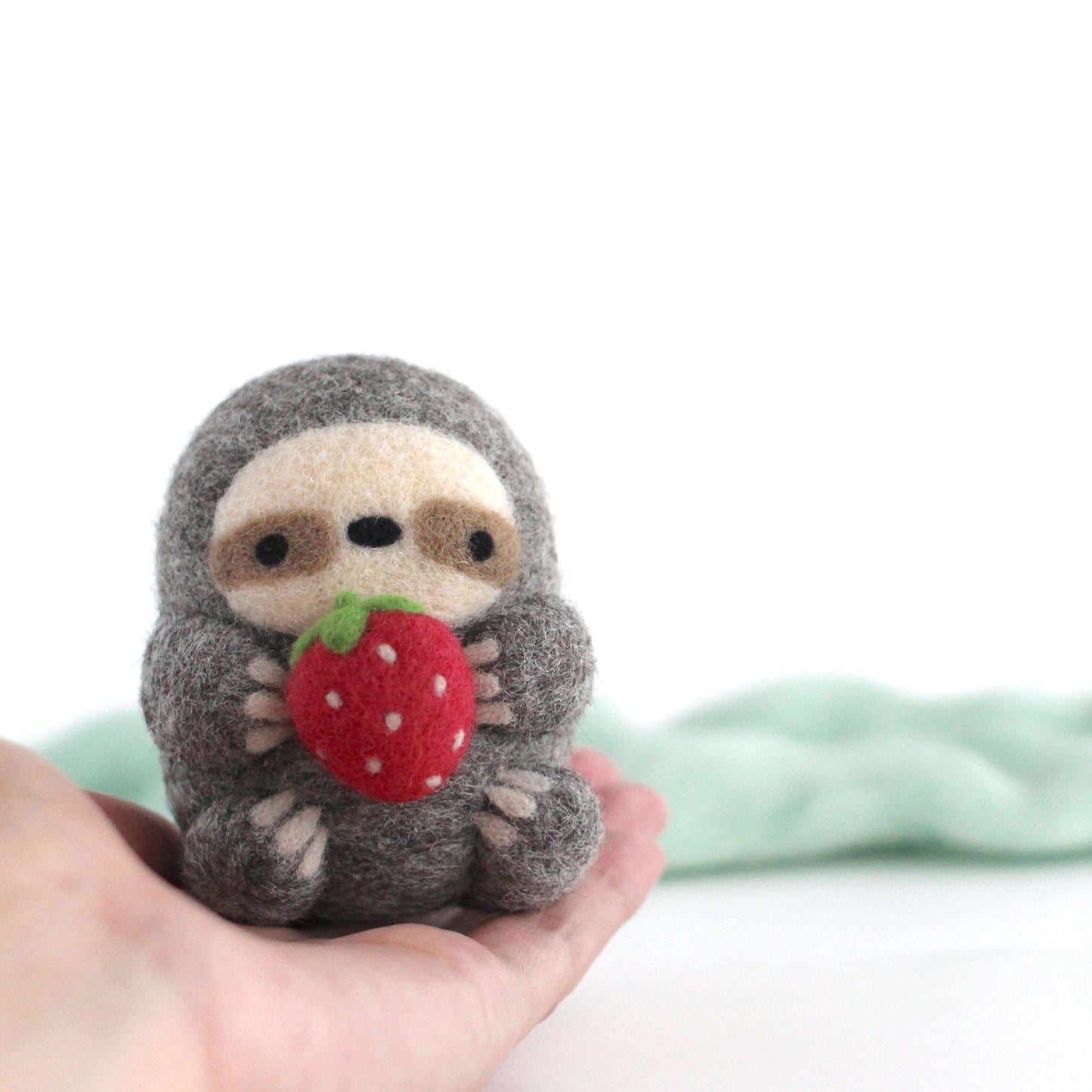 Needle Felted Sloth holding Strawberry