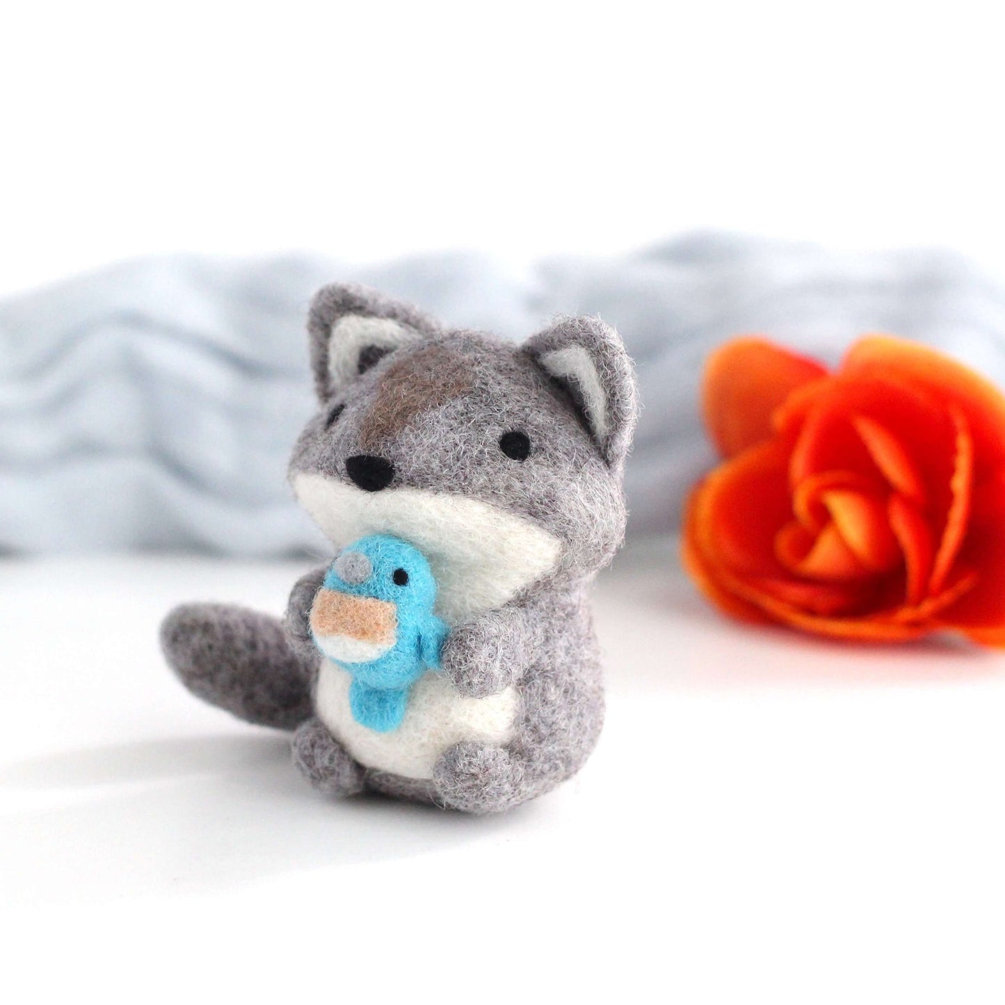 Needle Felted Wolf holding Bluebird