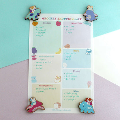 Grocery shopping list with colourful dragon knight wooden magnets on a pastel background 