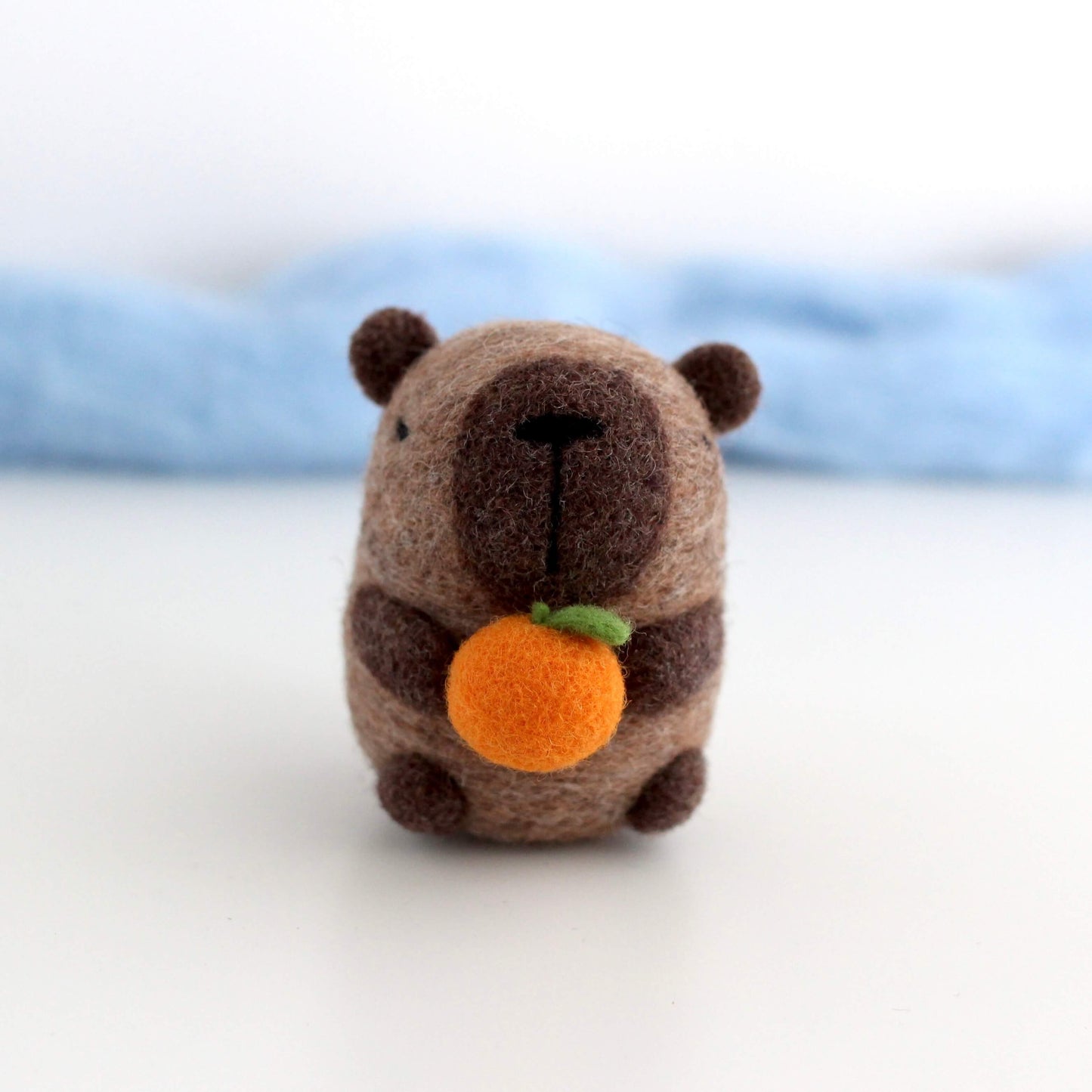 Needle Felted Capybara holding Orange