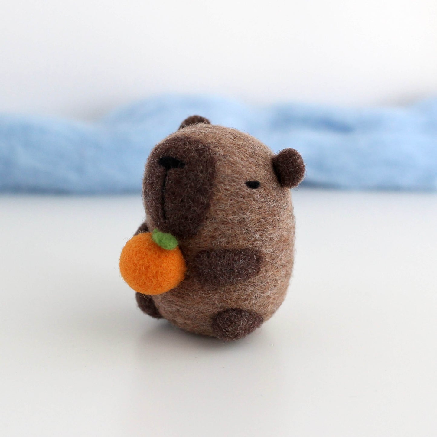 Needle Felted Capybara holding Orange