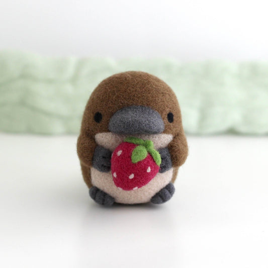 Needle Felted Platypus Holding Dark Red Strawberry