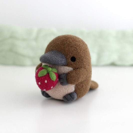 Needle Felted Platypus Holding Dark Red Strawberry