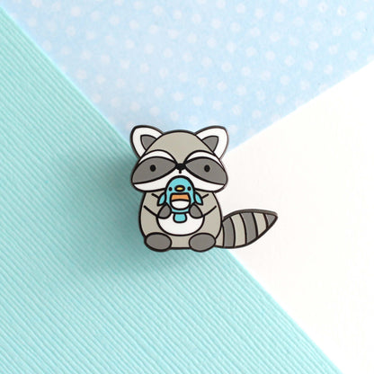 Raccoon holding Blue Bird Enamel Pin