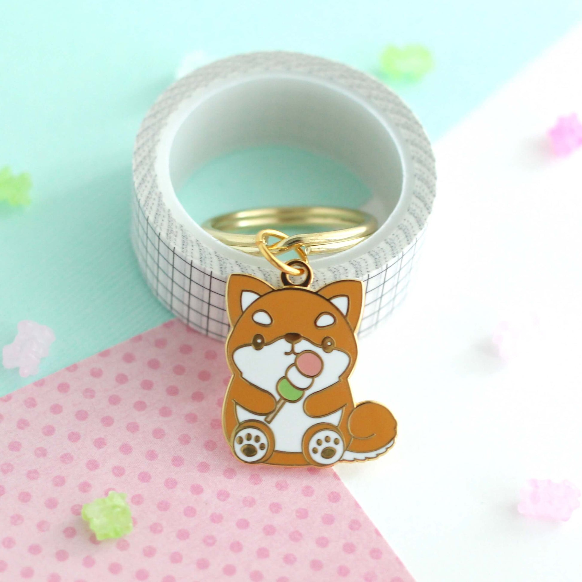 Shiba Inu holding a Dango Enamel Keychain