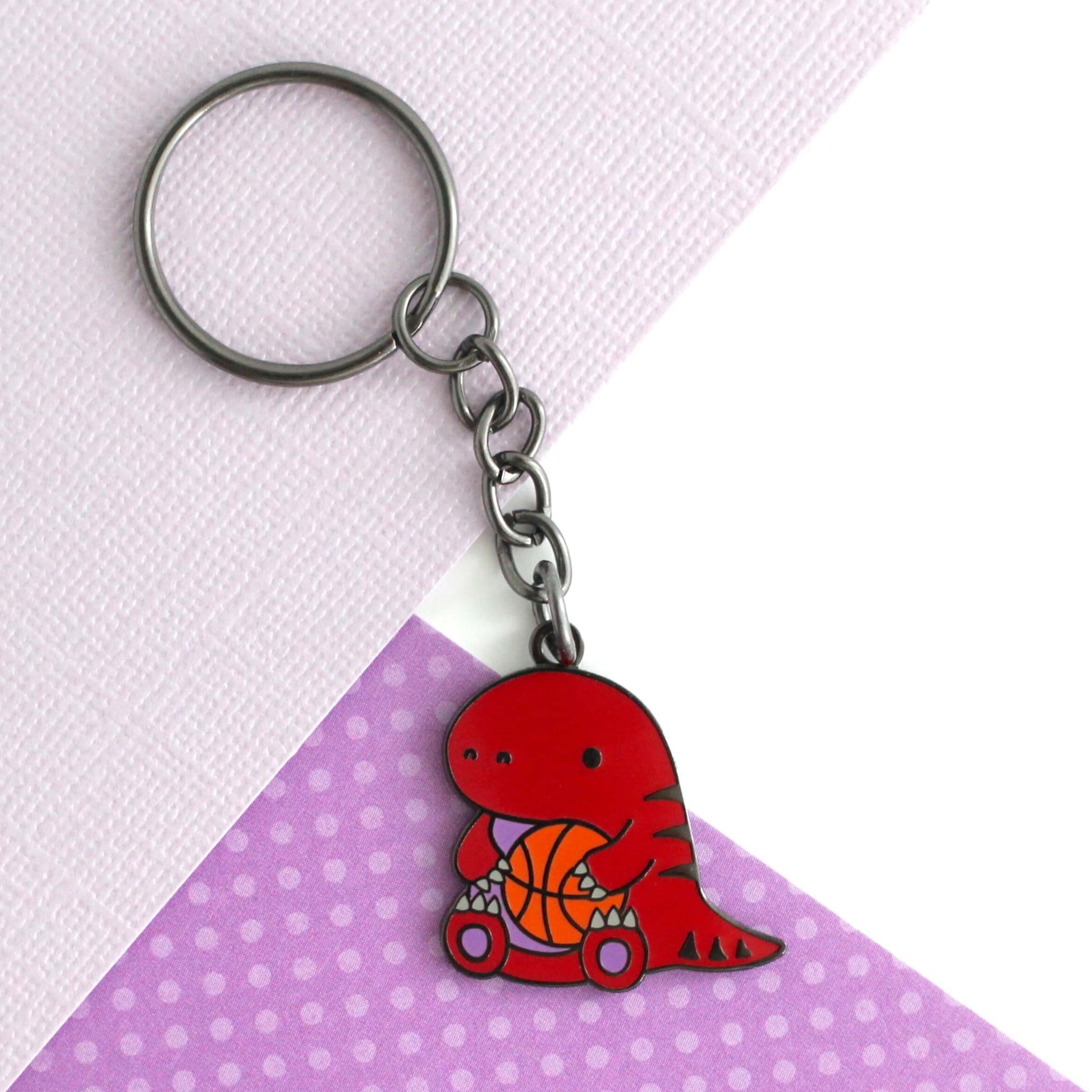 Toronto Raptor holding a Basketball Enamel Keychain