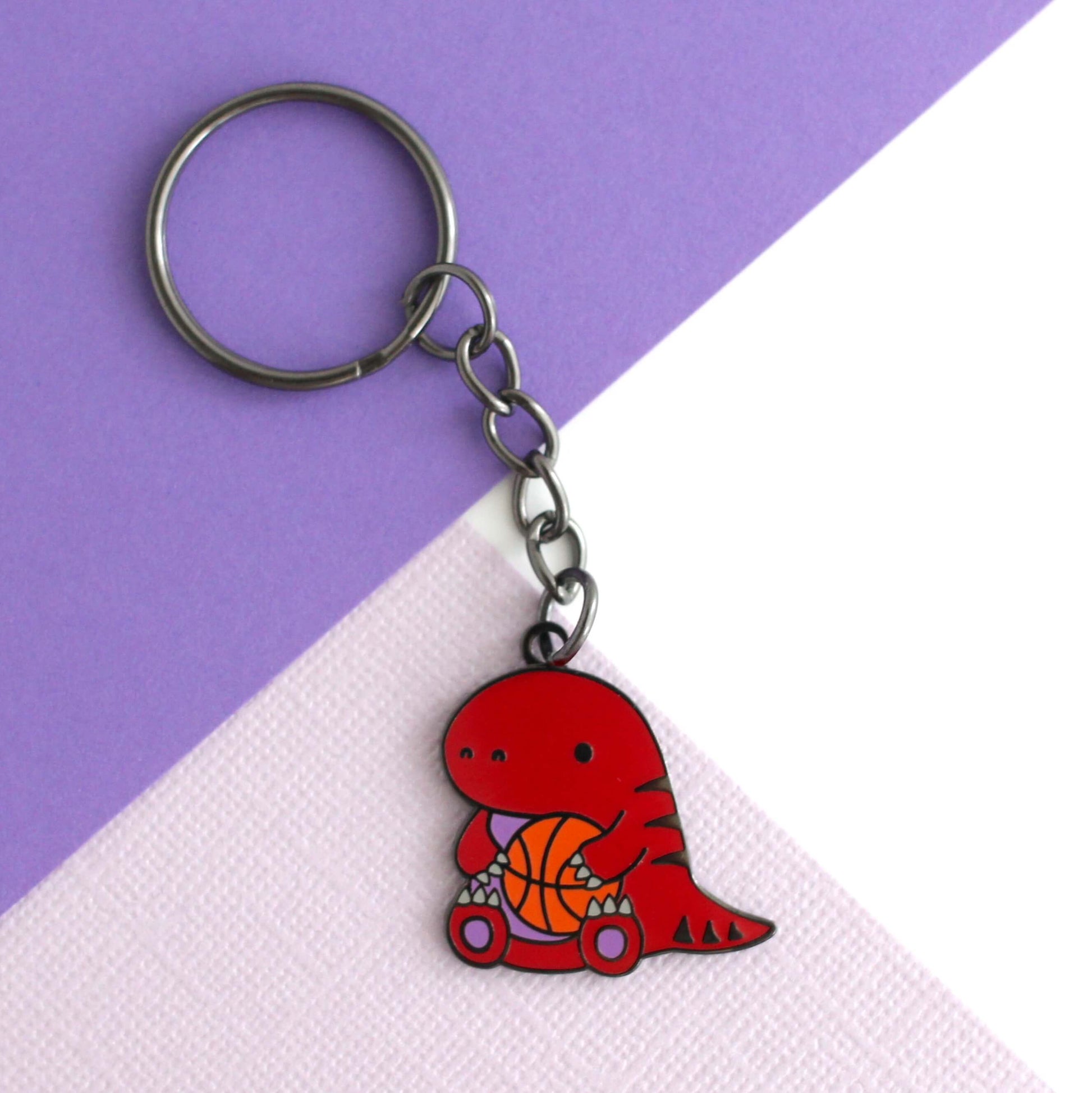 Toronto Raptor holding a Basketball Enamel Keychain