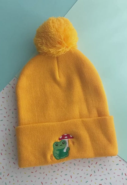 Pom-pom Beanie with Green Frog holding Mushroom Umbrella