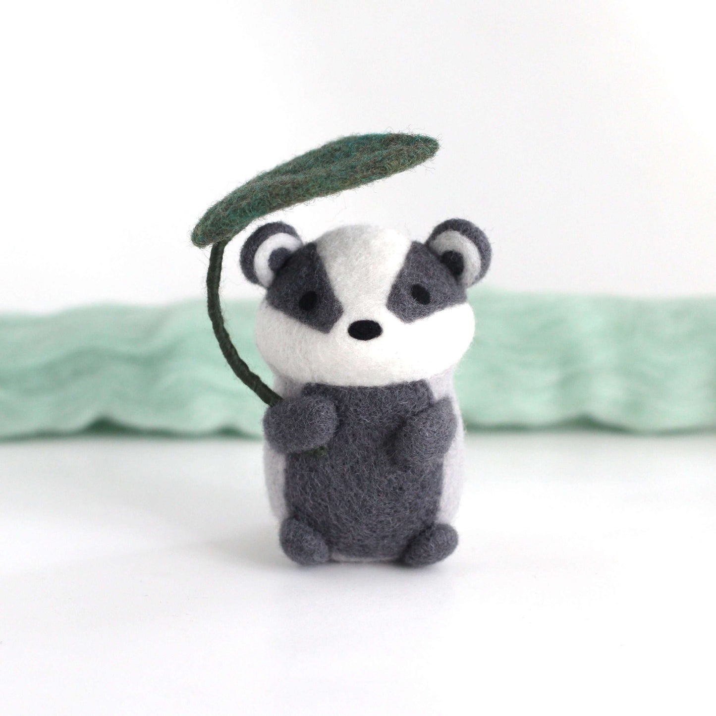 Needle Felted Badger Holding Leaf Umbrella by Wild Whimsy Woolies