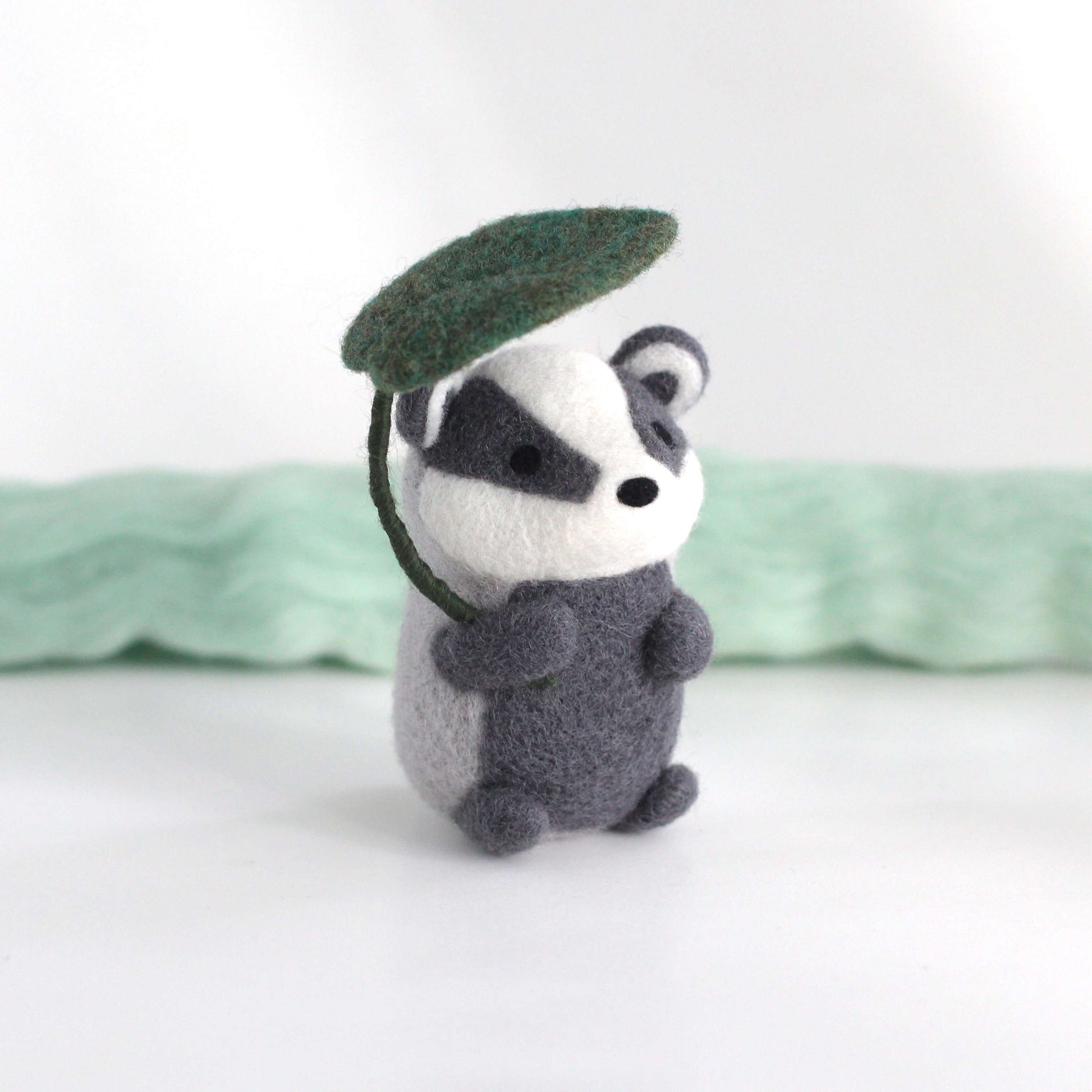 Needle Felted Badger Holding Leaf Umbrella by Wild Whimsy Woolies