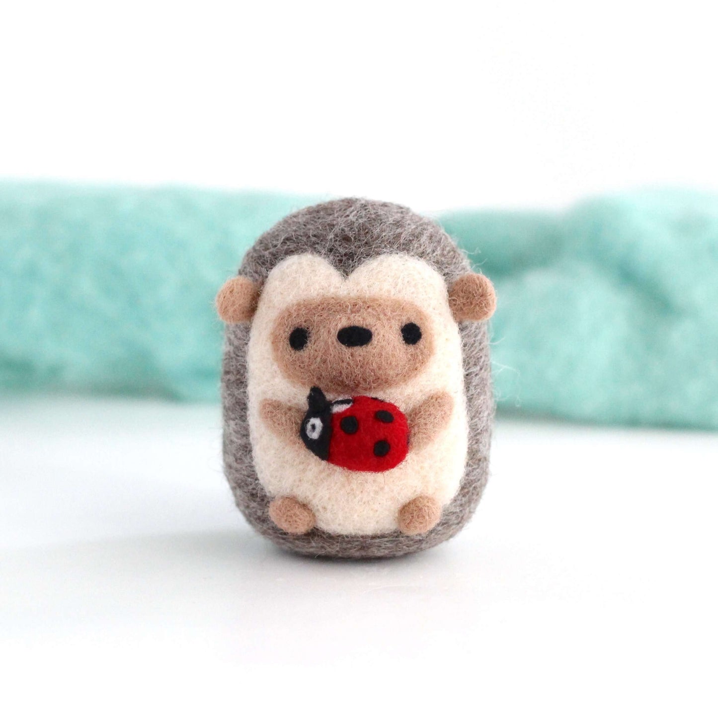 Needle Felted Hedgehog holding Ladybug