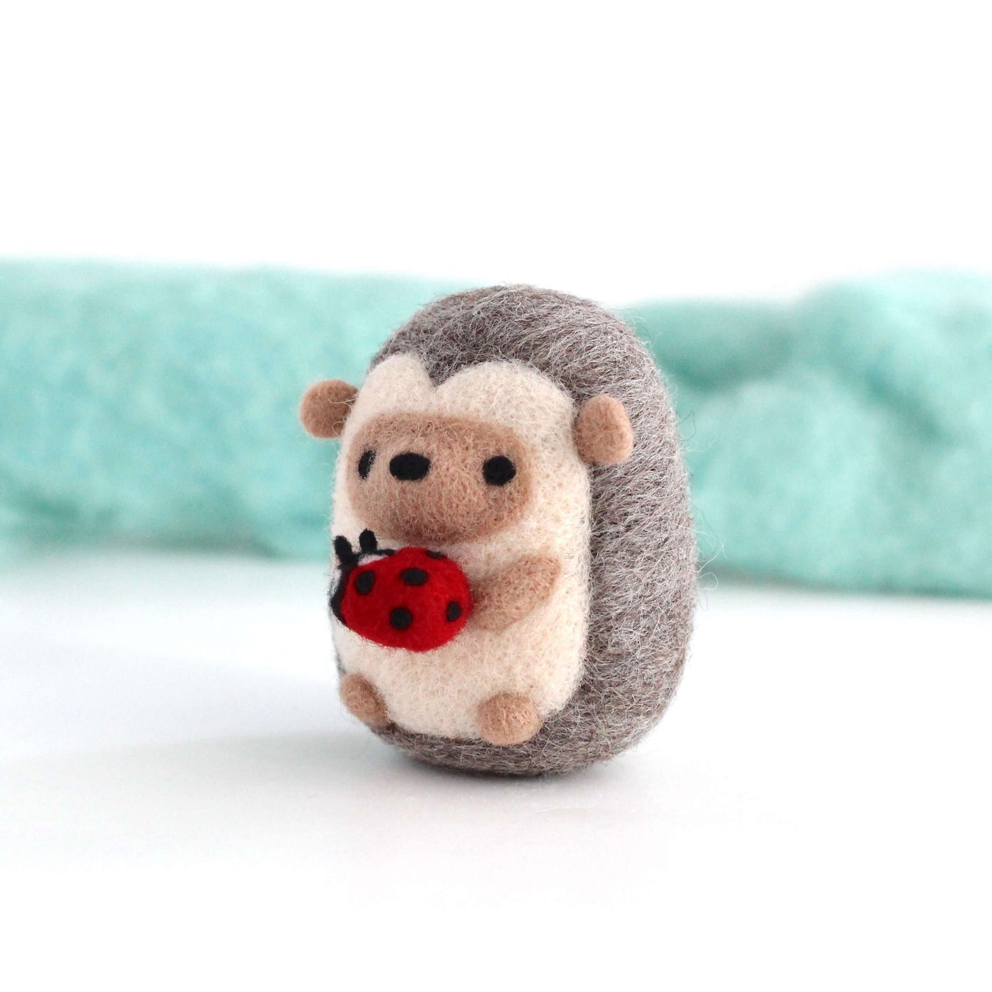 Needle Felted Hedgehog holding Ladybug