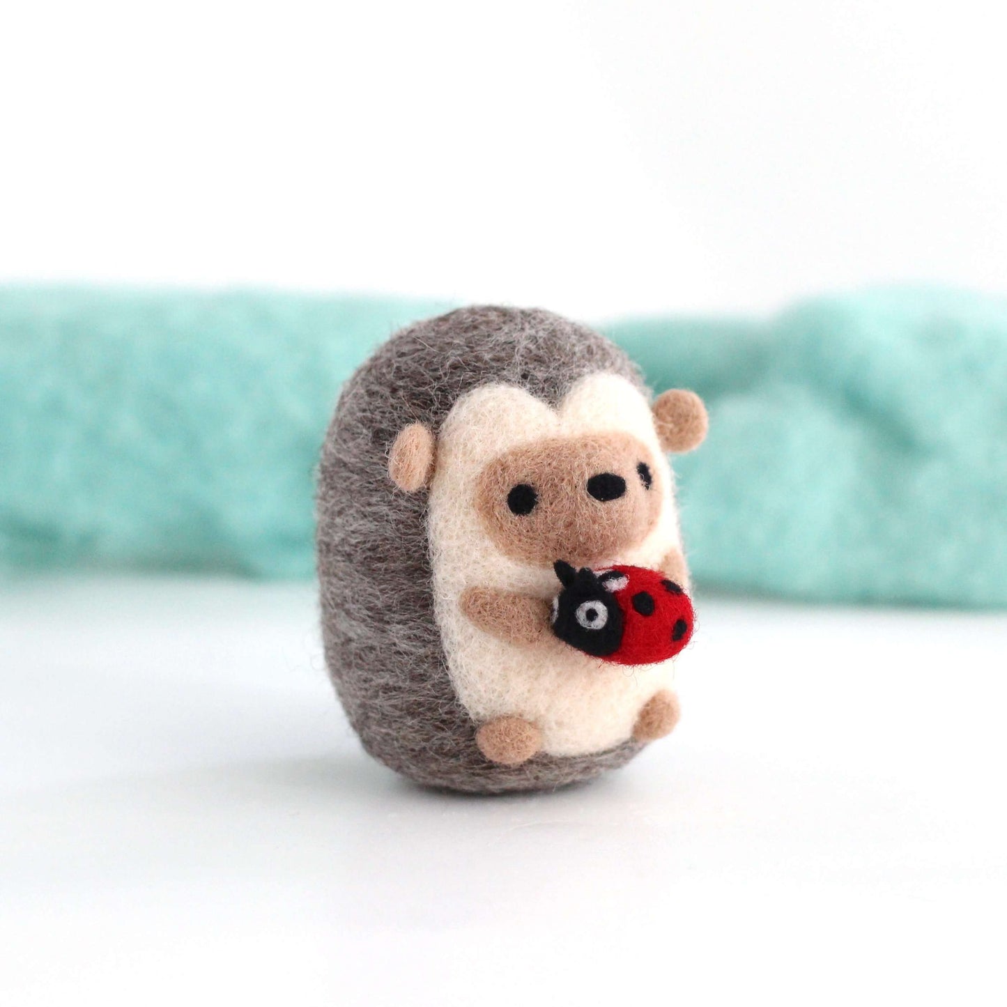 Needle Felted Hedgehog holding Ladybug