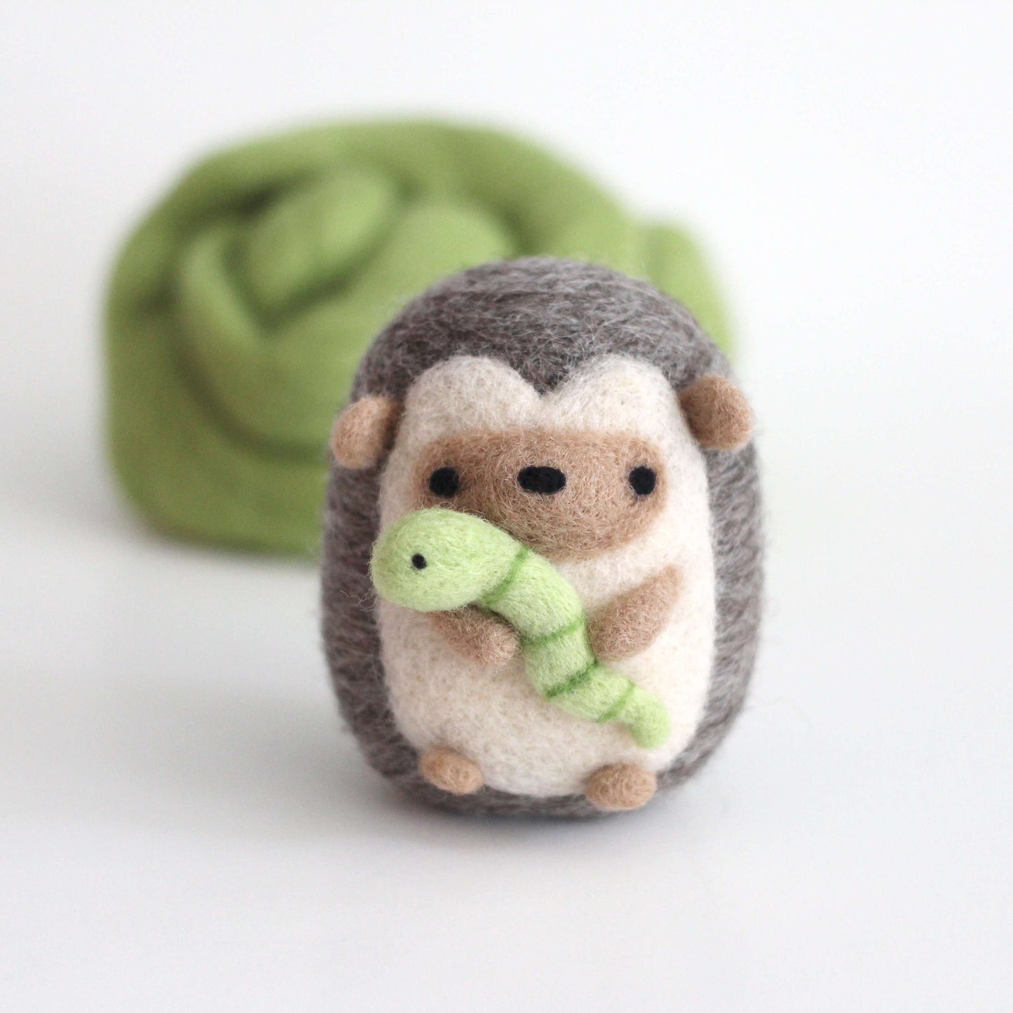 Needle Felted Hedgehog holding Worm by Wild Whimsy Woolies