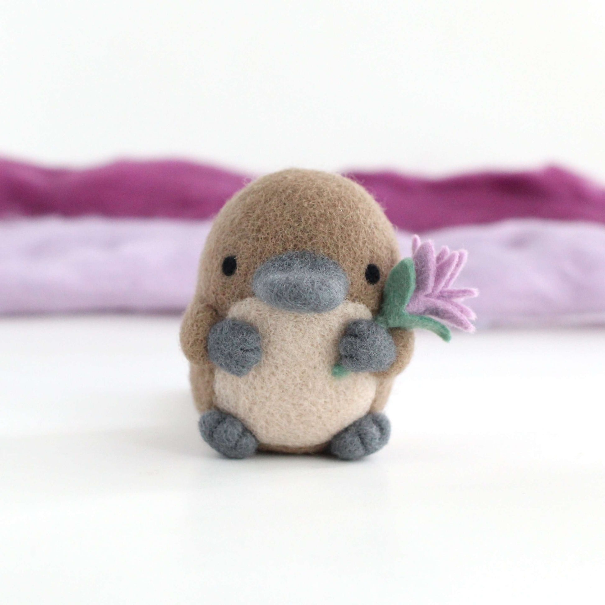 Needle Felted Platypus holding a Wildflower (Light purple) by Wild Whimsy Woolies