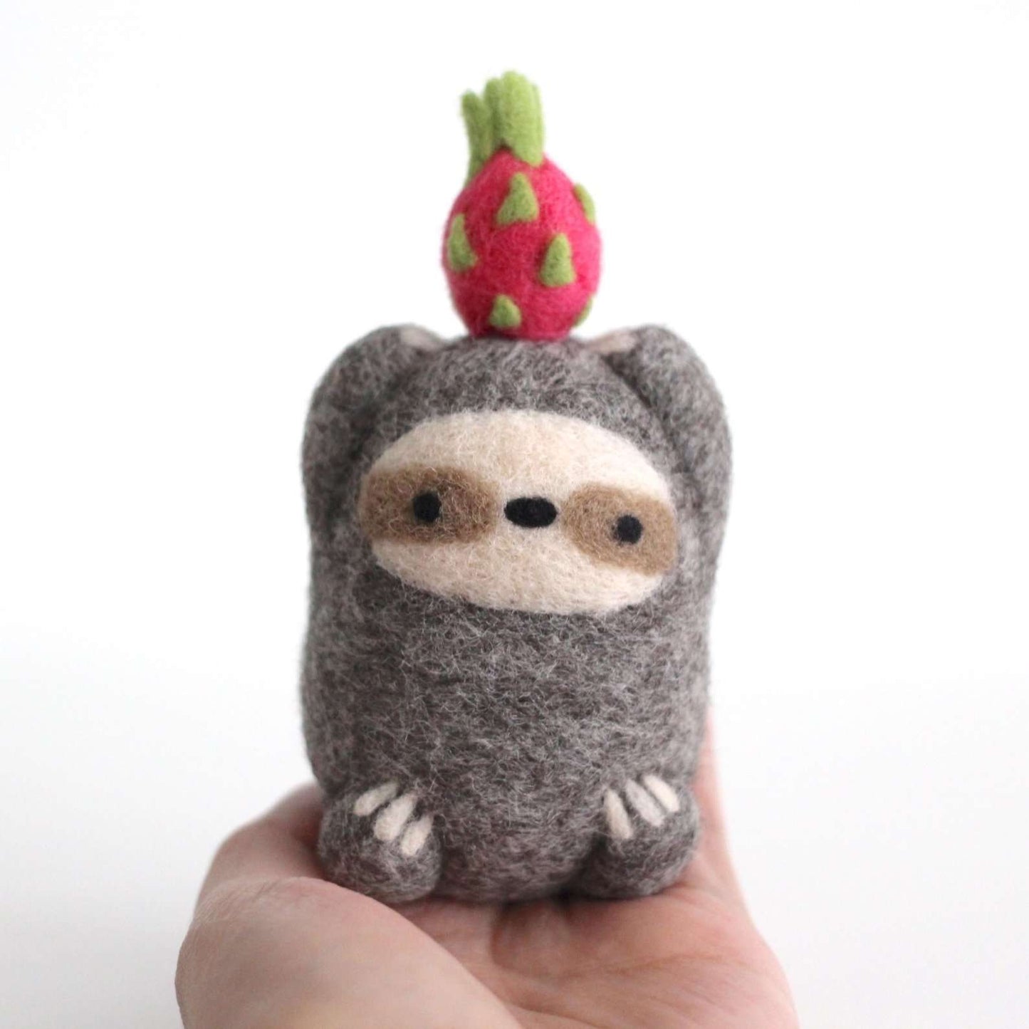 Needle Felted Sloth holding Dragon Fruit