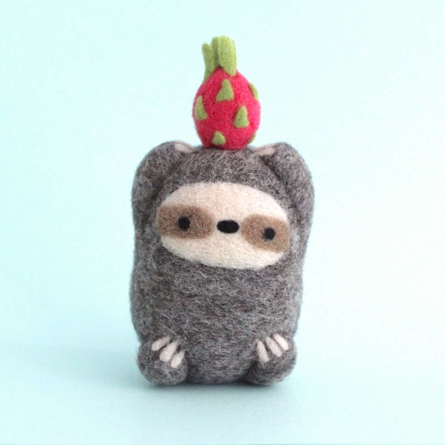 Needle Felted Sloth holding Dragon Fruit